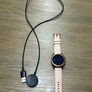 Excellent working galaxy 3 watch with a rose gold band, charger is included.